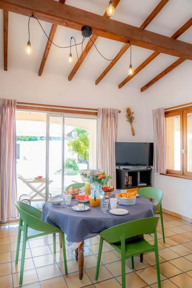 Salle à manger sous poutres apparentes, petit-déjeuner dressé